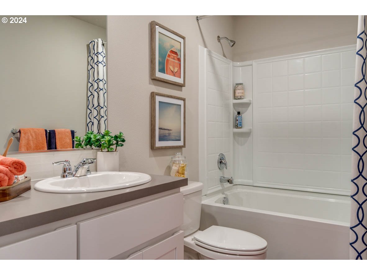 2993 V Street Springfield, OR 97477 - Photo 4 of 24 a bathroom with a sink a toilet and shower
