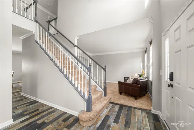 a view of entryway and hall with wooden floor