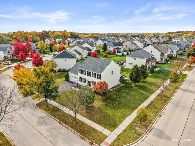 an aerial view of a house with a lake view