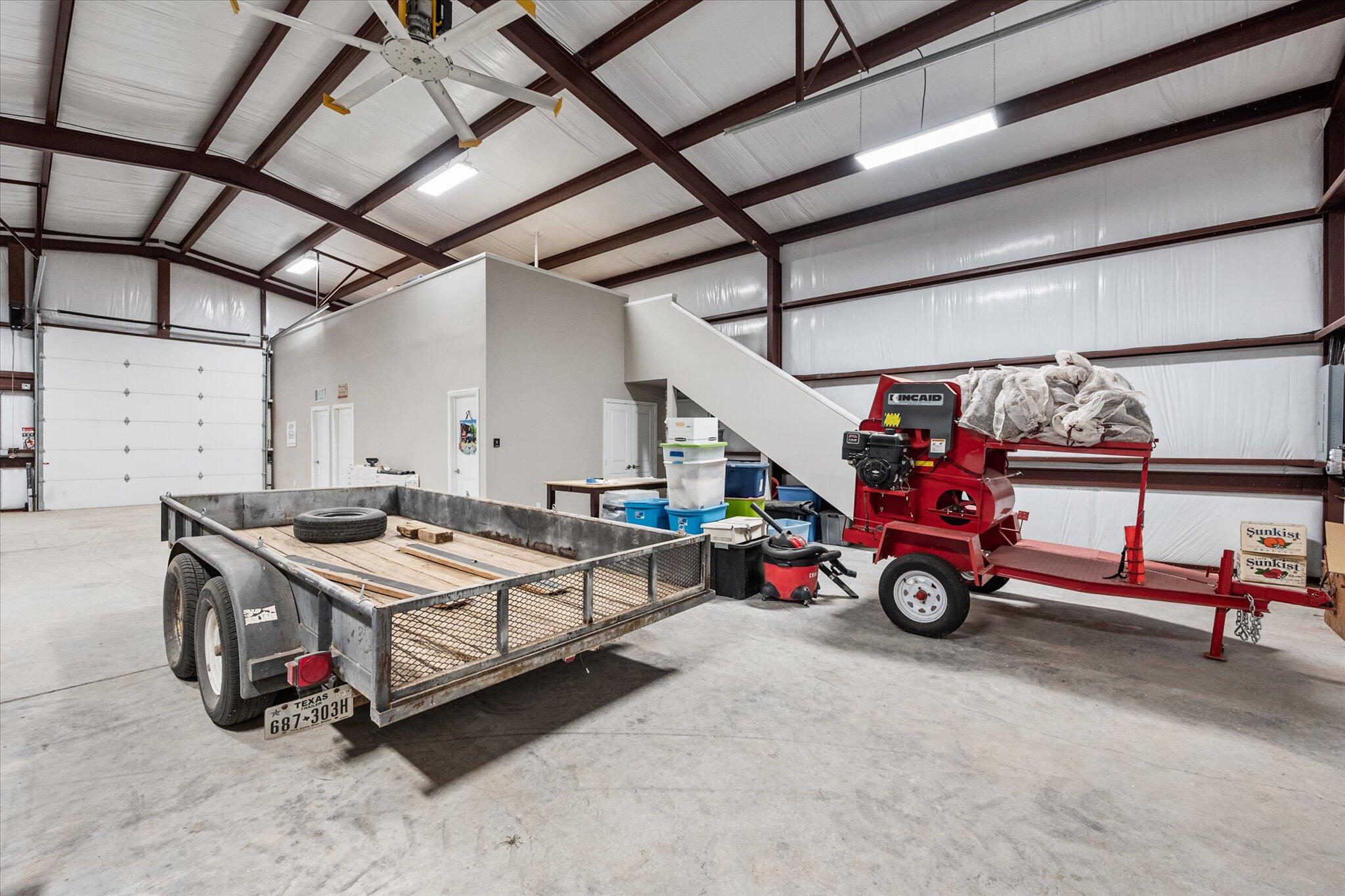 767 North Sandhill Road Tahoka, TX 79373 - Photo 13 of 27 a car and bike parked in a garage