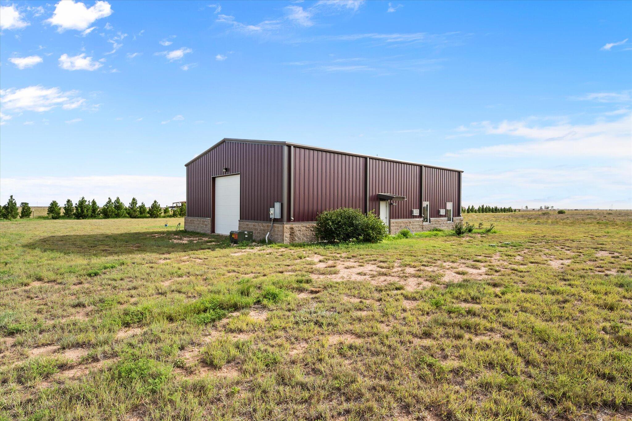 767 North Sandhill Road Tahoka, TX 79373 - Photo 15 of 27 a view of a garden with a building in the background