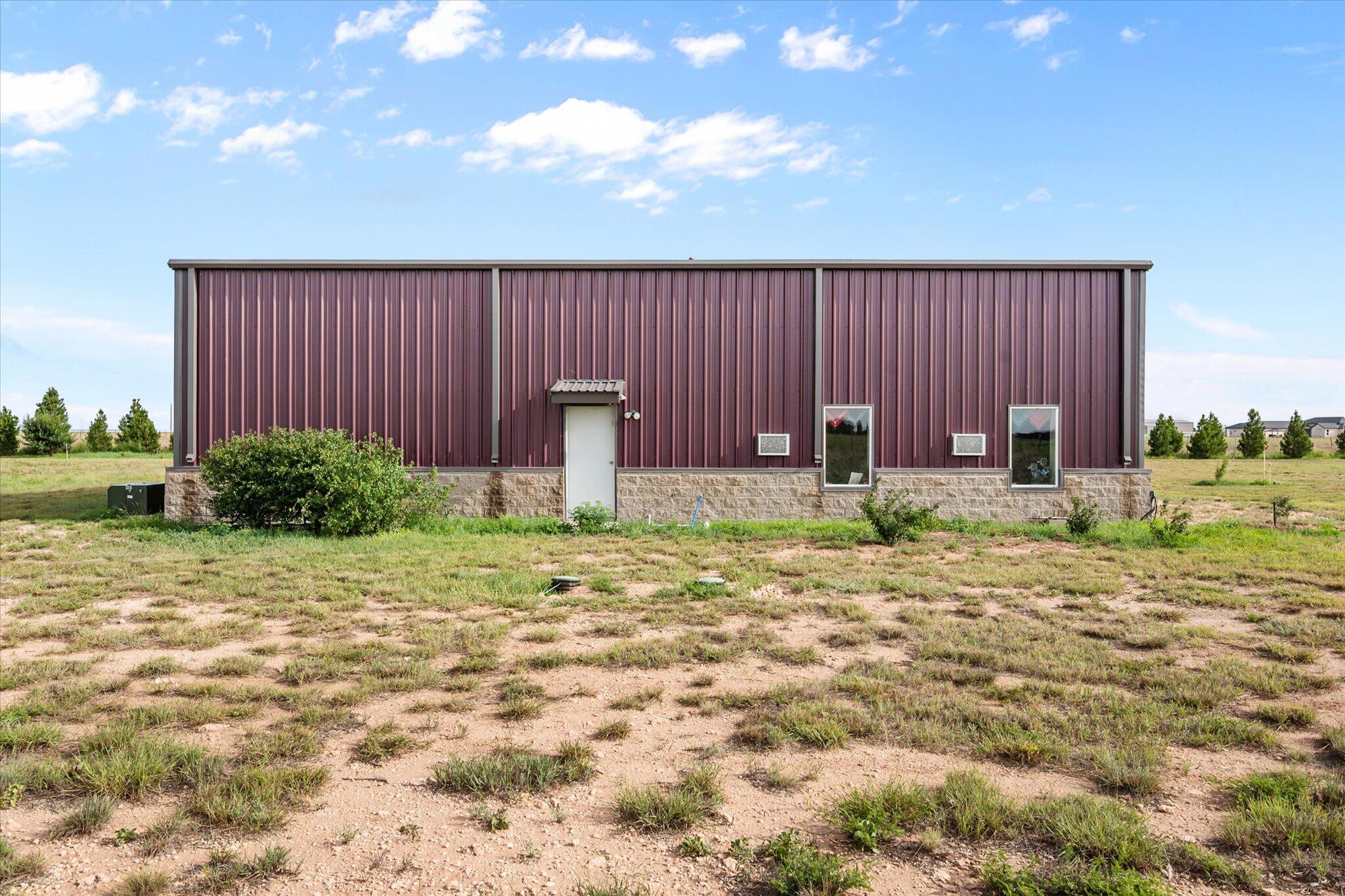 767 North Sandhill Road Tahoka, TX 79373 - Photo 16 of 27 a backyard of a house with lots of green space and outdoor seating
