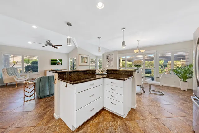 a kitchen with granite countertop a sink and cabinets