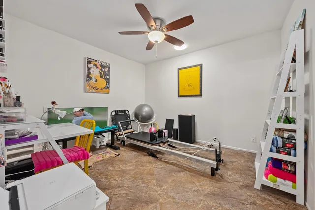 a workspace with furniture and ceiling fan