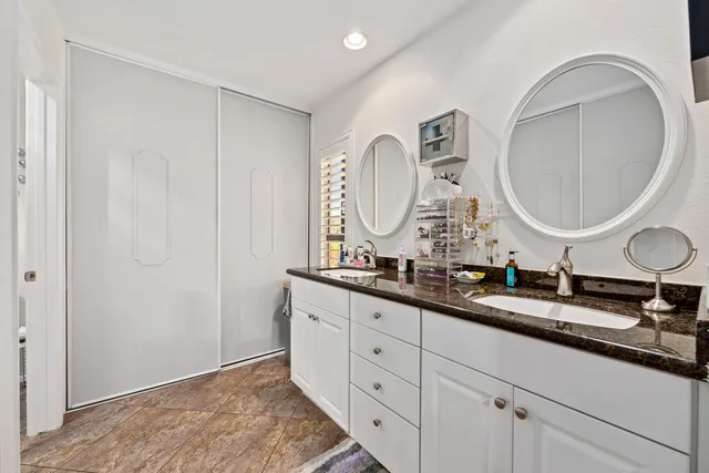 a bathroom with a double vanity sink and a mirror