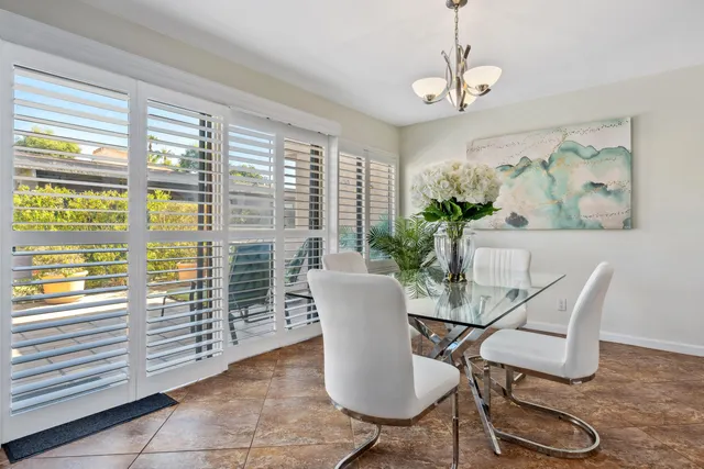 a dining room with furniture a window and wooden floor