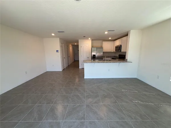 a view of a kitchen with a sink and cabinets