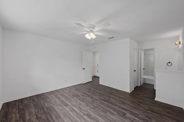 a view of an empty room and wooden floor