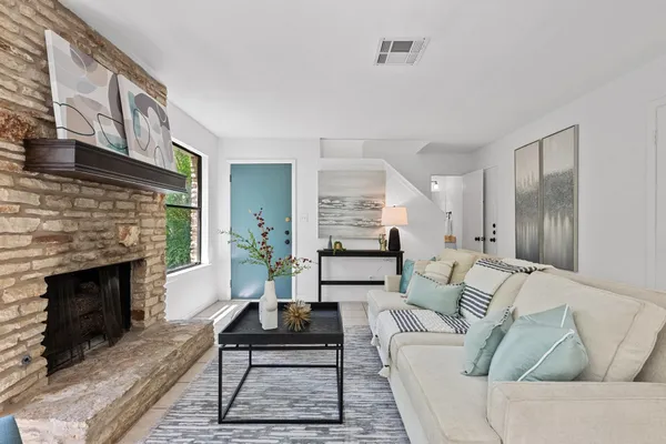 a living room with furniture and a fireplace