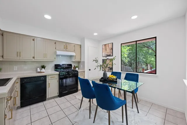 a kitchen with stainless steel appliances granite countertop a stove a sink dishwasher and a microwave