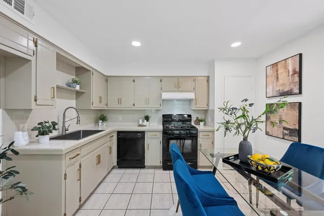 a kitchen with stainless steel appliances a stove refrigerator sink and cabinets