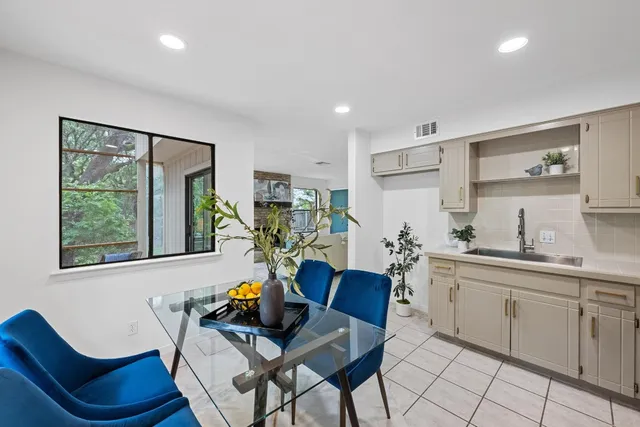 a view of a dining room with furniture a rug and wooden floor