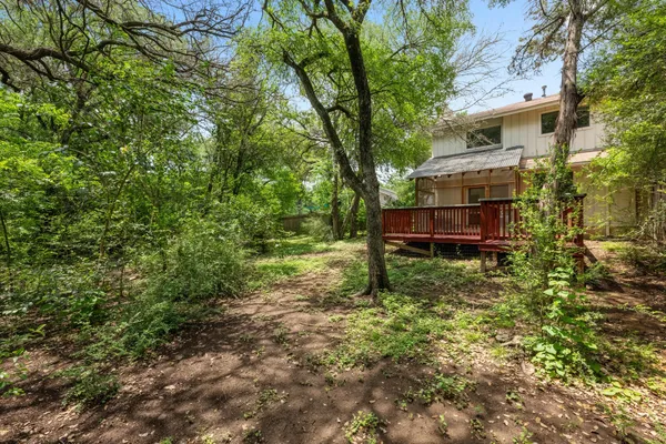 a view of a house with a yard and sitting area