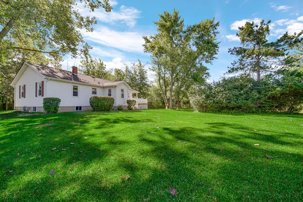 a front view of house with yard and green space