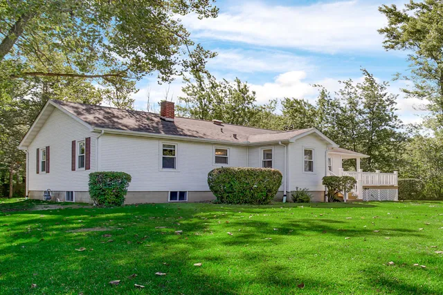 a view of a house with a yard and garden