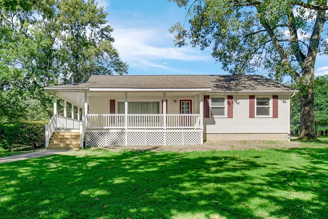 a house that has a big yard in front of it