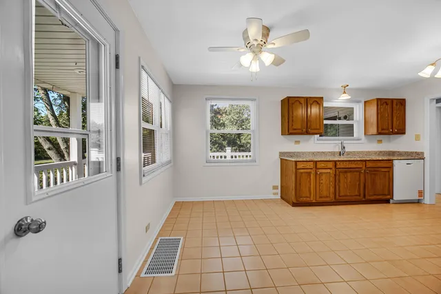 a view of kitchen with windows and refrigerator