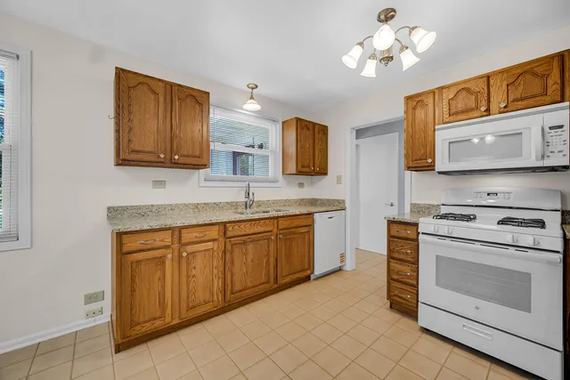 a kitchen with stainless steel appliances granite countertop a stove sink and microwave