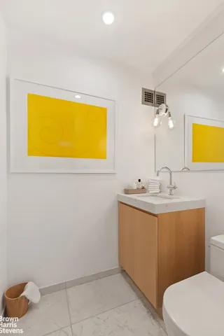 a bathroom with a toilet sink and mirror