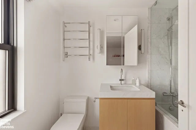 a bathroom with a sink a toilet and mirror