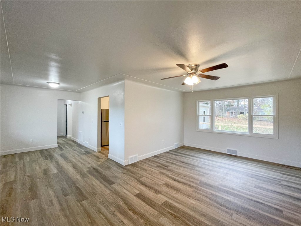 4949 East Radio Road Youngstown, OH 44515 - Photo 6 of 37 Spare room with hardwood / wood-style floors and ceiling fan