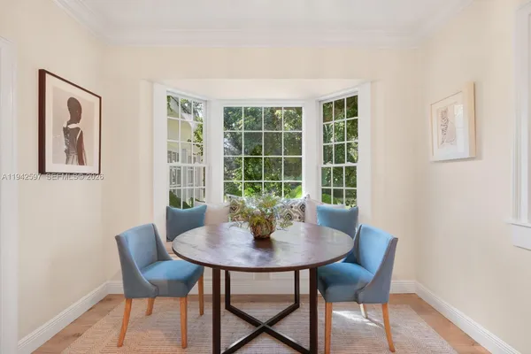 a dining room with furniture and window