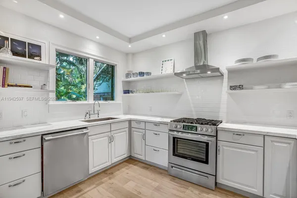 a kitchen with cabinets a sink and appliances