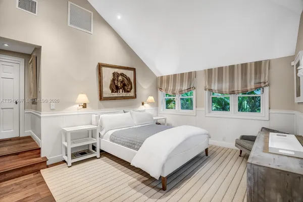 a bedroom with a large bed and a couch