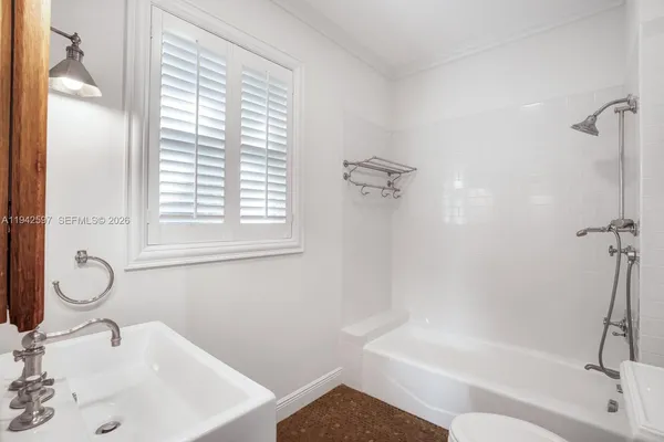 a bathroom with a sink a toilet and a tub
