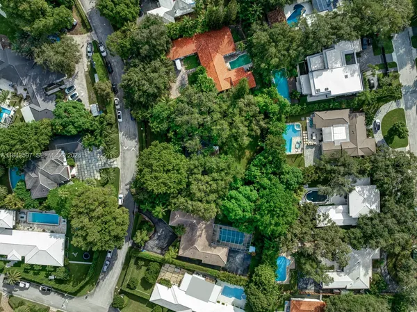 an aerial view of a house with an outdoor space and street view