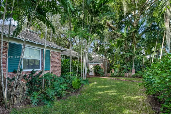 front view of a house with a tree