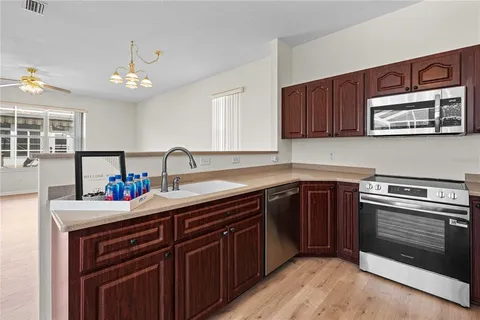 a kitchen with stainless steel appliances granite countertop a sink stove and cabinets