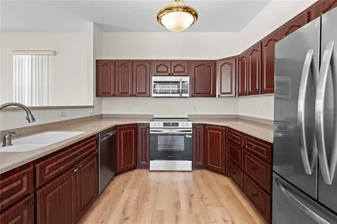 a kitchen with stainless steel appliances granite countertop a sink and stove top oven