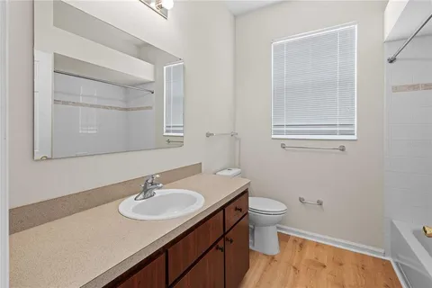 a bathroom with a sink toilet and a mirror
