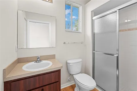 a bathroom with a sink toilet a mirror and vanity