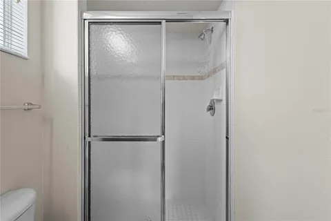 a bathroom with a glass shower door
