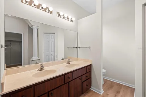 a bathroom with a double vanity sink and a mirror