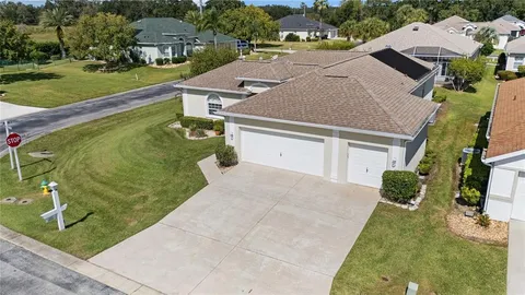 an aerial view of a house with a swimming pool