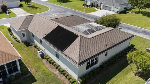 an aerial view of a house with a swimming pool yard and outdoor seating