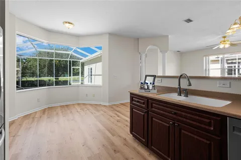 a kitchen with a sink and wooden cabinets