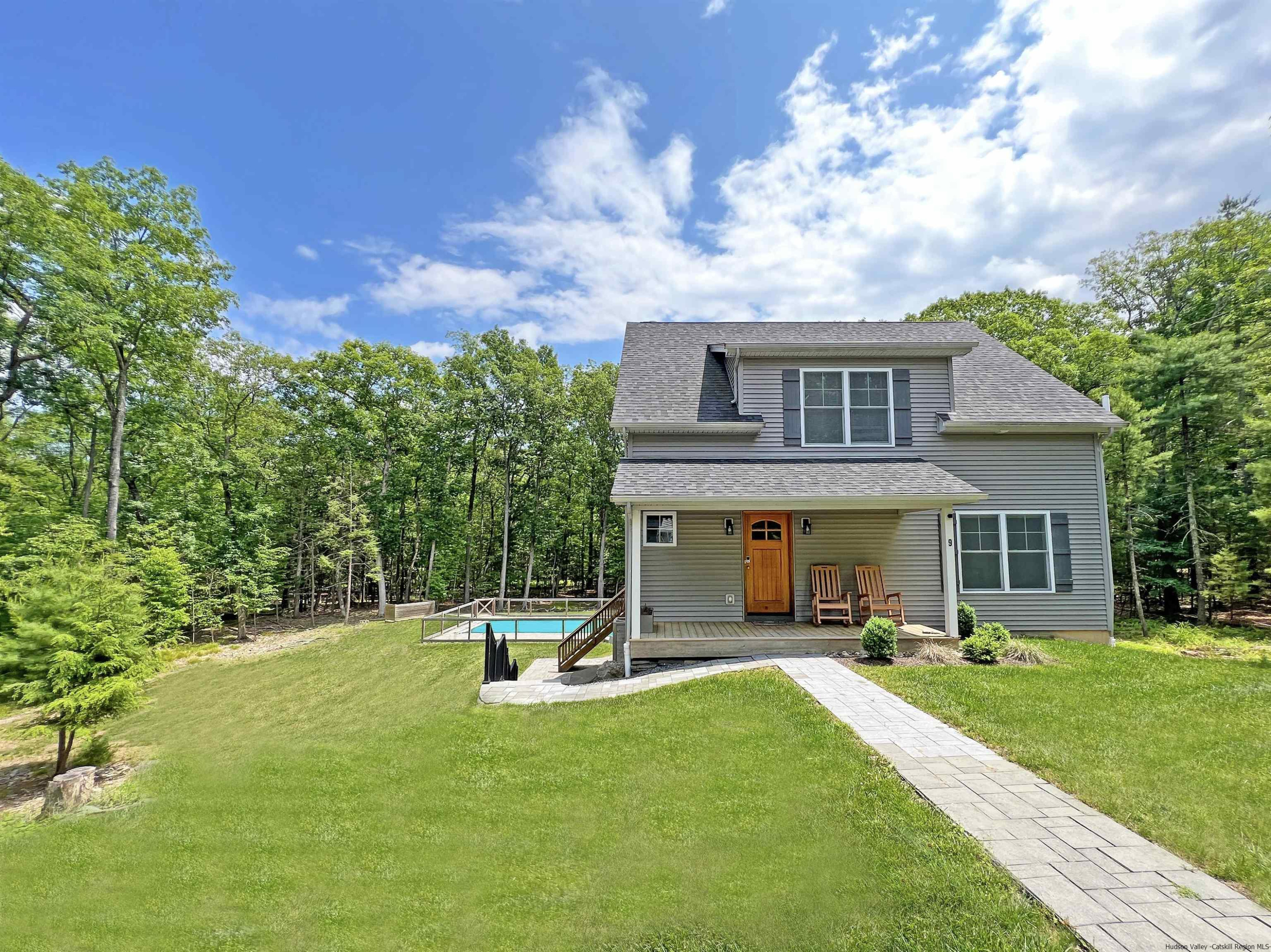 a view of a house with a yard patio and fire pit