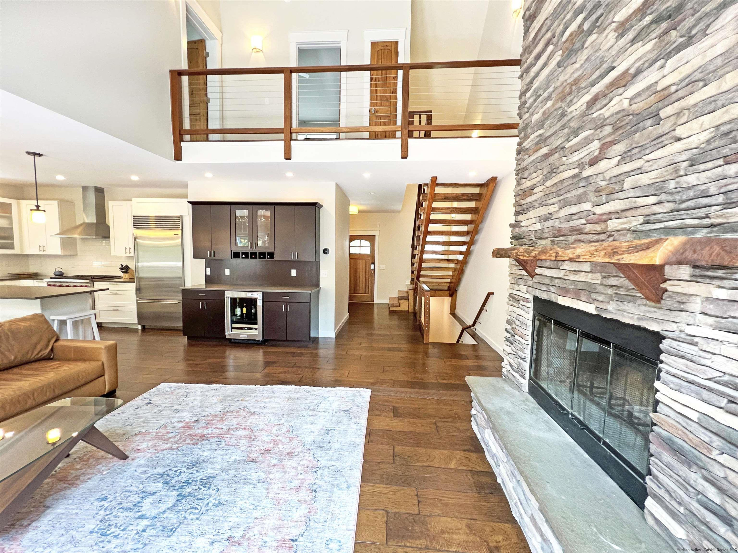 9 Magnolia Kingston, NY 12401 - Photo 15 of 33 a living room with stainless steel appliances furniture wooden floor and a fireplace