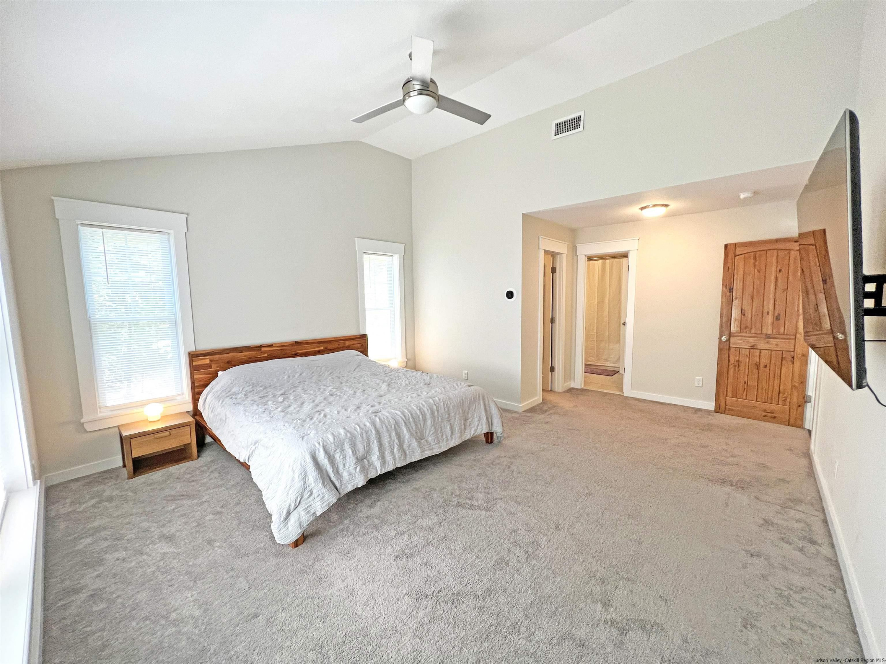 9 Magnolia Kingston, NY 12401 - Photo 19 of 33 a bedroom with a bed and a chandelier