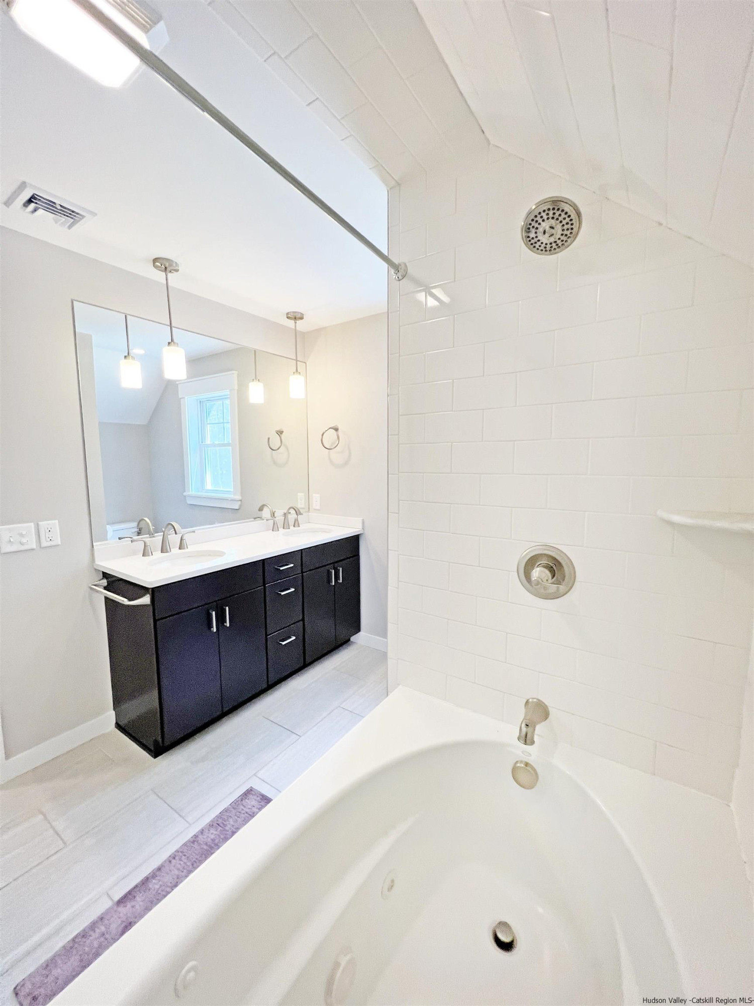 9 Magnolia Kingston, NY 12401 - Photo 23 of 33 a spacious bathroom with a tub sink shower and mirror