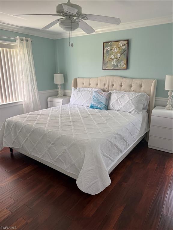 760 Augusta Boulevard, Unit D204 Naples, FL 34113 - Photo 30 of 32 a bedroom with a bed and wooden floor