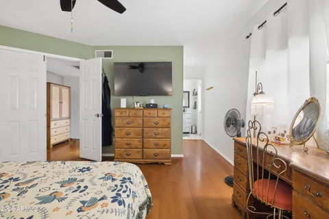 a bedroom with a bed chandelier and a window