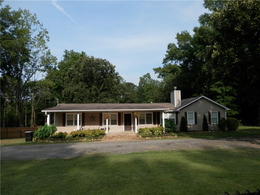 a front view of house with a garden and patio