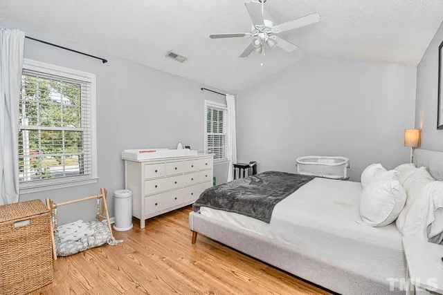 a spacious bedroom with two beds and a dresser