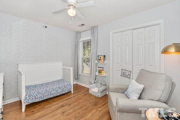 8824 Whitby Court Raleigh, NC 27615 - Photo 15 of 25 a living room with furniture and wooden floor