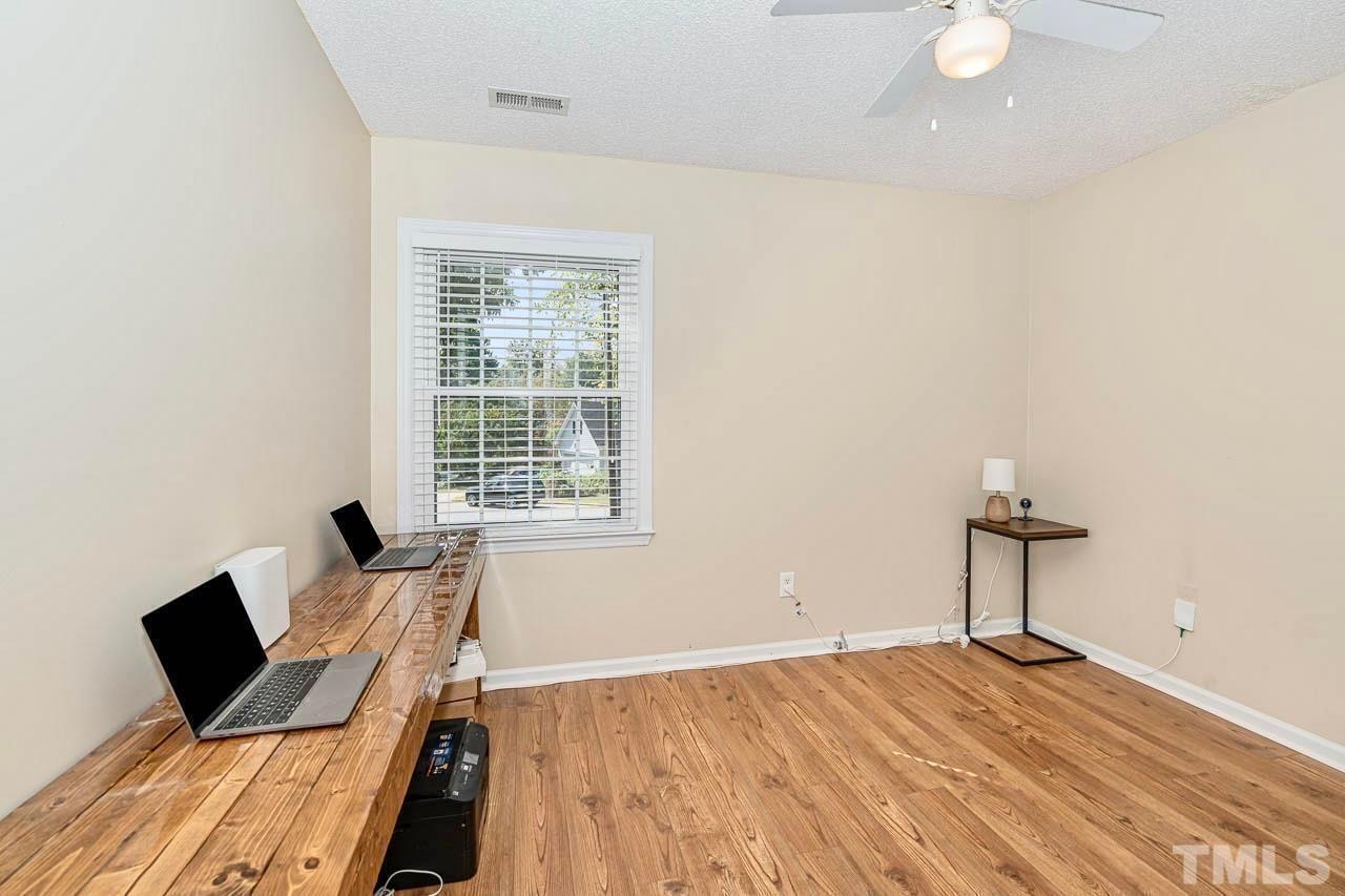 8824 Whitby Court Raleigh, NC 27615 - Photo 18 of 25 a bedroom with a bed and a window